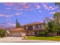 Beautiful two-story home with a red tile roof, front lawn, and an attached two-car garage at 9021 Feather River Ct, Las Vegas, NV 89117