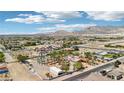 Sweeping aerial view of the property showcasing its large lot, lush landscaping, and mountain backdrop at 9111 W Stephen Ave, Las Vegas, NV 89149