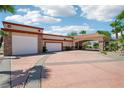 Expansive driveway leading to multiple garages and the home's portico entrance at 9111 W Stephen Ave, Las Vegas, NV 89149