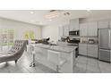 Bright kitchen featuring granite countertops, stainless steel appliances, and modern lighting at 9161 Rolling Sky Dr, Las Vegas, NV 89178