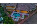 An aerial view of a pool and spa area, with a built in fireplace and beautiful landscaping at 9865 Bright Angel Way, Las Vegas, NV 89149