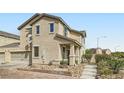 Charming two-story house with desert landscaping, a two-car garage, and a welcoming front porch at 987 Wembly Hills Pl, Henderson, NV 89011