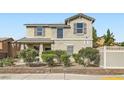 Well-maintained two-story home with mature landscaping and blooming bushes adding curb appeal at 987 Wembly Hills Pl, Henderson, NV 89011