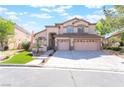 Charming two-story home featuring a three-car garage, manicured lawn, and a welcoming entrance at 1016 Eaglewood Dr, Las Vegas, NV 89144