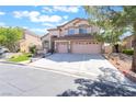 Charming two-story home featuring a three-car garage, manicured lawn, and a welcoming entrance at 1016 Eaglewood Dr, Las Vegas, NV 89144