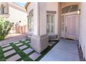 Inviting front entrance featuring a decorative door, manicured landscaping, and modern stonework at 1016 Eaglewood Dr, Las Vegas, NV 89144