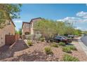 Two story home with desert landscaping and a driveway with parking at 10329 Walworth Ave, Las Vegas, NV 89166
