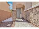 Front entrance with stone columns, stone wall and brick paver walkway at 10329 Walworth Ave, Las Vegas, NV 89166