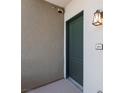 Condo entrance featuring a well-lit wall sconce and the unit number on the right at 128 Los Cabos Dr # 301, Las Vegas, NV 89144