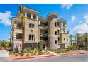 Attractive multi-story building featuring balconies, a tower design, and desert landscaping at 128 Los Cabos Dr # 301, Las Vegas, NV 89144