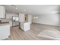 Kitchen and open living room area, filled with stainless steel appliances and a center island at 1425 Gable Falls Dr # 93, North Las Vegas, NV 89084