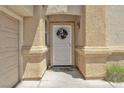 Charming front door entrance framed by decorative columns and a festive wreath at 1476 Evening Song Ave, Henderson, NV 89012