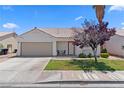 Inviting single-story home with well-kept lawn, desert landscaping, and covered entry at 1728 Crystal Chimes Dr, Las Vegas, NV 89106