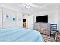 The main bedroom features a large bed, a dresser with a TV, and an open doorway to the main bathroom at 2225 Chandler Ranch Pl, Laughlin, NV 89029