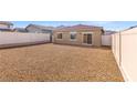 Low maintenance backyard with gravel landscaping and a fresh white fence at 2727 Avril Point St, Las Vegas, NV 89156
