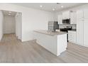 Bright kitchen featuring stainless steel appliances, a kitchen island, and sleek white cabinetry at 2727 Avril Point St, Las Vegas, NV 89156