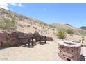 Inviting outdoor patio featuring comfortable seating and a cozy fire pit for enjoying the natural desert surroundings at 275 Vegas Dr, Goodsprings, NV 89019