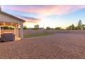 Expansive backyard with gravel landscaping, a covered patio, and an artificial turf area at 298 Grant Ridge Dr, Henderson, NV 89012