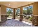Open patio view with stone pillars offering a glimpse of the meticulously landscaped front yard at 3188 Via Da Vinci, Henderson, NV 89044
