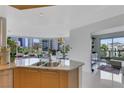Well-lit kitchen featuring a breakfast bar with seating and city views visible through the windows at 322 Karen Ave # 308, Las Vegas, NV 89109