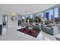 Living room with city views, tile floors, and comfortable seating near floor-to-ceiling windows at 322 Karen Ave # 308, Las Vegas, NV 89109