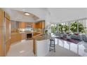 Bright open concept eat-in kitchen and living room space with seating, modern appliances, and city views at 322 Karen Ave # 308, Las Vegas, NV 89109