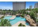 Resort-style pool area with lush landscaping, waterfalls and a hot tub at 322 Karen Ave # 308, Las Vegas, NV 89109