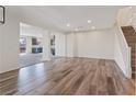Spacious living room showcasing sleek floors, recessed lighting, and an open floor plan into the kitchen and dining area at 340 Autumn Palace Ct, Las Vegas, NV 89144