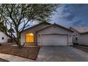 Inviting single-story home featuring a two-car garage and drought resistant landscaping at 3426 Side Saddle Ct, North Las Vegas, NV 89032