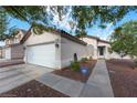 Single-story home featuring desert landscaping, an attached two-car garage and a cozy front porch at 3913 Lilac Haze St, Las Vegas, NV 89147