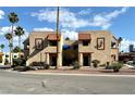 Beige condo buildings showcasing a unique brown framed entry with palm tree landscaping at 4151 Sanderling Cir # 351, Las Vegas, NV 89103