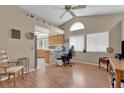 Cozy living space with wood floors, a vaulted ceiling, and an arch window for natural light at 4628 Standing Bluff Way, Las Vegas, NV 89130