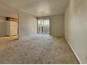 Bright living room with neutral carpet and sliding glass doors to the patio at 4943 Indian River Dr # 133, Las Vegas, NV 89103