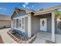 Inviting front entry with a decorative glass door and gray exterior siding at 5417 Eastbrook Dr, Las Vegas, NV 89142
