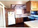 View of kitchen with tile countertops and classic appliances at 671 Bourbon St, Pahrump, NV 89048