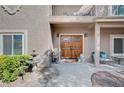 Elegant front entrance showcasing a double door, water feature, and cozy seating area at 6821 Jeanette St, Las Vegas, NV 89131