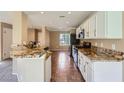 Bright kitchen with stainless steel appliances, granite countertops, and tile floors at 7382 Elbridge Way, Las Vegas, NV 89113