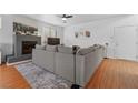 Spacious living room featuring a cozy gray sofa, fireplace and hardwood floors at 8036 Eurostar St, Las Vegas, NV 89131