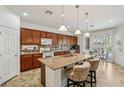 Bright kitchen featuring granite counters, stainless steel appliances, and an island with bar seating at 8224 Fowler Falls Ct, North Las Vegas, NV 89085