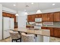 Bright kitchen featuring granite counters, stainless steel appliances, and an island with bar seating at 8224 Fowler Falls Ct, North Las Vegas, NV 89085