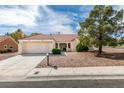 Charming single-story home with a two-car garage, tile roof, and well-kept desert landscaping at 9105 Marble Dr, Las Vegas, NV 89134