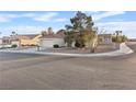 Well-manicured lawn, attractive landscaping, with a glimpse of the home, garage, and tile roof in a serene neighborhood at 9105 Marble Dr, Las Vegas, NV 89134