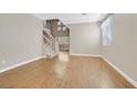 Spacious living area with gleaming hardwood floors and staircase access at 927 Clear Diamond Ave, Las Vegas, NV 89123