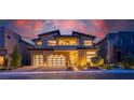 Beautiful two-story home showcasing manicured landscaping, stone accents, and a spacious three-car garage at dusk at 10748 Steel Ridge Ct, Las Vegas, NV 89135