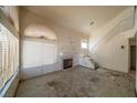 Spacious living room with a fireplace, a vaulted ceiling and access to the staircase at 1436 Padre Bay Dr, Las Vegas, NV 89108