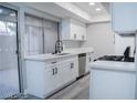 Bright kitchen featuring white cabinets, black hardware, a stainless dishwasher, and a black faucet at 1440 Vegas Valley Dr # 3, Las Vegas, NV 89169