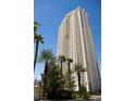 Exterior view of a modern condo high-rise building in Las Vegas with palm trees at 145 E Harmon Ave # 1120, Las Vegas, NV 89109