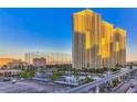 Modern high-rise condo buildings at dawn with palm trees, and the monorail in Las Vegas at 145 E Harmon Ave # 1120, Las Vegas, NV 89109