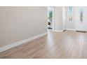 Bright and open entryway featuring sleek laminate flooring, white trim, and a welcoming atmosphere for guests and residents at 1500 E Laguna St, Pahrump, NV 89048