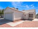 Inviting single-story home featuring a two-car garage, tiled roof, and beautiful desert landscaping at 1740 Leaning Pine Way, Las Vegas, NV 89128